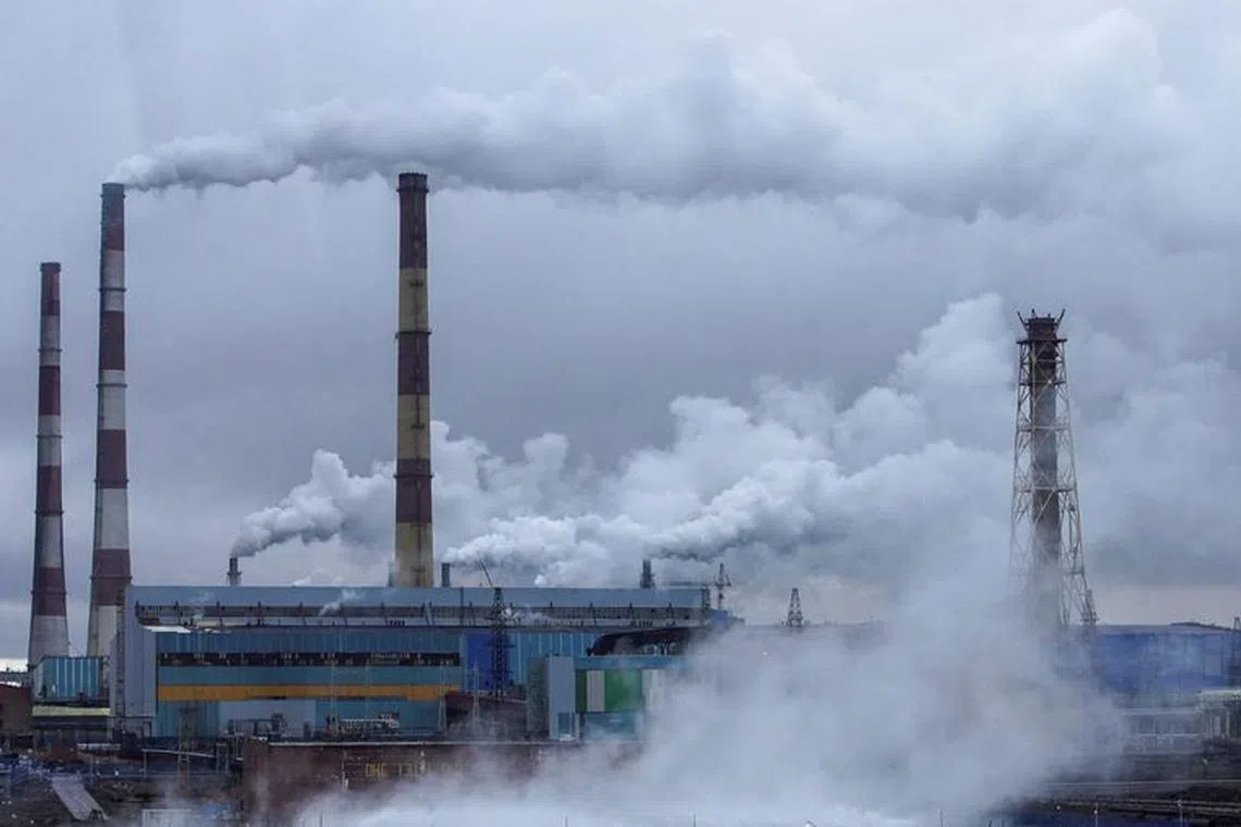 FILE PHOTO: A view through a bus window shows Nadezhda Metallurgical Plant of Nornickel company, the world's leading nickel and palladium producer, in the Arctic city of Norilsk, Russia August 22, 2021. REUTERS/Tatyana Makeyeva/File Photo