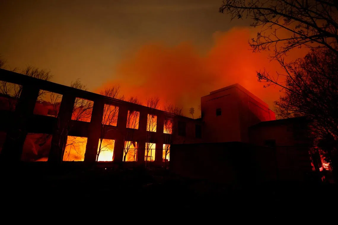 More than 100,000 people were ordered to evacuate as dry, hurricane-force winds spread flames across parched ground.