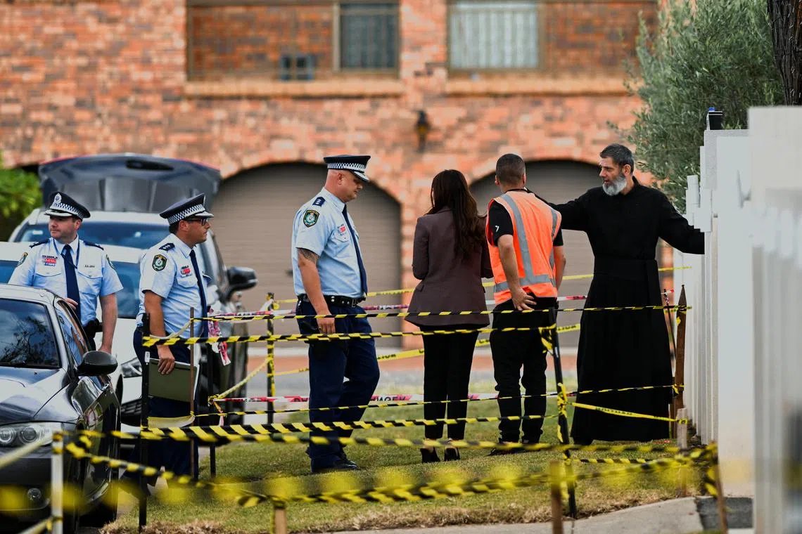 Police enter the Assyrian Christ The Good Shepherd Church with a clergyman after a knife attack took place during a service on Monday night, in Wakely, in Sydney, Australia, April 17, 2024. REUTERS/ Jaimi Joy