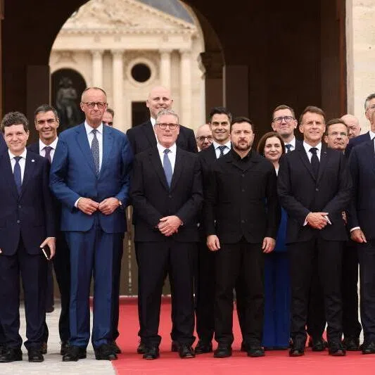 British Prime Minister Keir Starmer (centre left), French President Emmanuel Macron (centre right) and Ukrainian President Volodymyr Zelensky (centre) pose for a family picture with heads of states and governments before a summit of the Coalition of the Willing to support Ukraine in Paris on July 13, 2026.