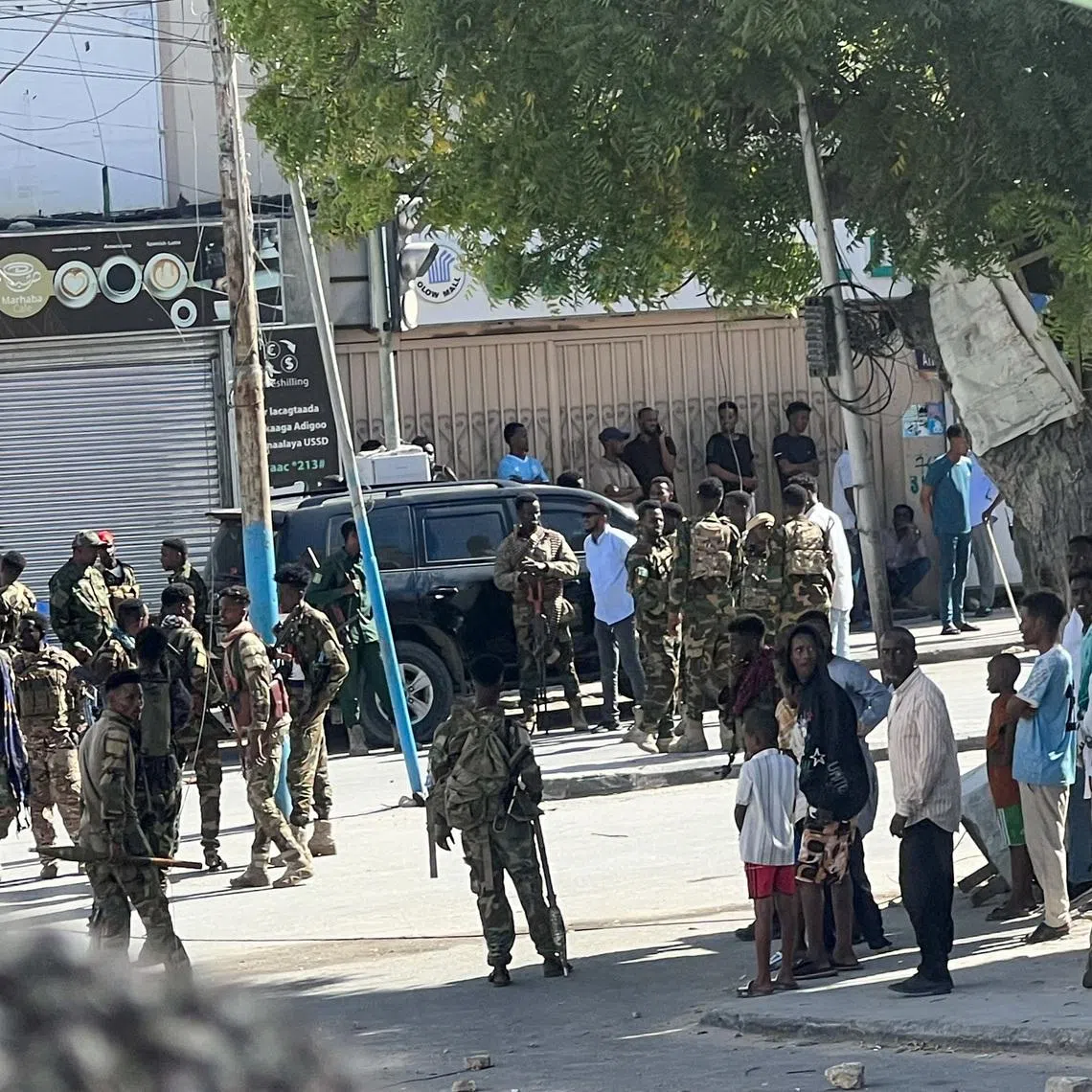 Members of Somali government forces stand among civilians at a street junction ahead of a planned protest against Somalia's President Hassan Sheikh Mohamud over his decision to remain in office after his term expired last month, in Mogadishu, Somalia, June 4, 2026. Picture taken with a mobile phone. REUTERS/Feisal Omar