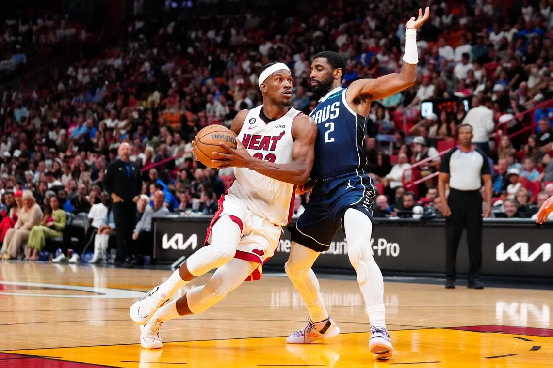 Miami Heat forward Jimmy Butler dribbling the ball past Dallas Mavericks guard Kyrie Irving during the second quarter at Miami-Dade Arena. He scored 35 points as the Heat won 129-122.