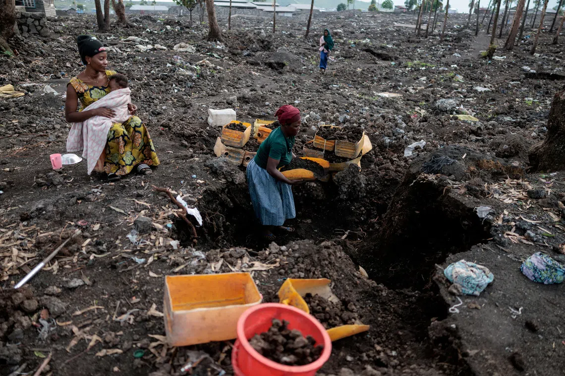 FILE PHOTO: Kahindo, an internally displaced woman, who said they could not return home because it was destroyed during the fighting, gathers volcanic gravel to sell at an IDP's camp which was emptied after the M23 rebels ordered many displaced people to leave the camps in Mugunga district, near Goma, in eastern Democratic Republic of Congo, March 22, 2025. REUTERS/Zohra Bensemra/File Photo