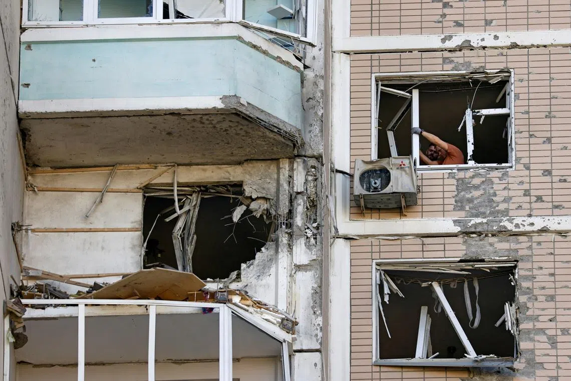 Residents clear broken windows in a damaged apartment building following a Ukrainian drone attack in the course of Russia-Ukraine conflict in Krasnogorsk, in the Moscow region, Russia May 17, 2026. REUTERS/Stringer