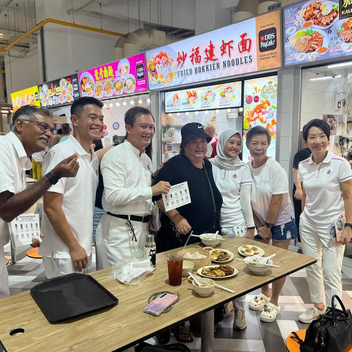 The PAP's Jurong East-Bukit Batok GRC candidates (from left) Murali Pillai, David Hoe, Lee Hong Chuang, Rahayu Mahzam (third from right) and Grace Fu (right) on a walkabout at Bukit Batok West Hawker Centre on April 29.