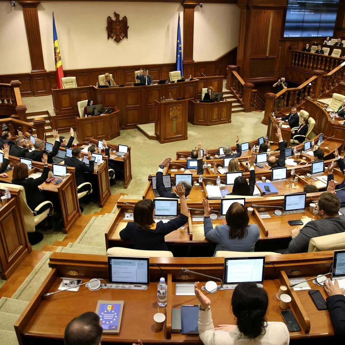FILE PHOTO: Moldovan lawmakers attend a parliamentary session held to vote on approving the country's new prime minister in Chisinau, Moldova, October 31, 2025. REUTERS/Vladislav Culiomza/File Photo