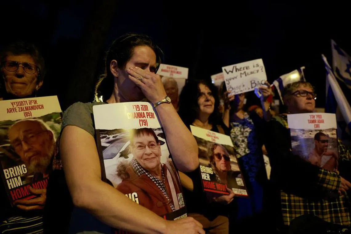 FILE PHOTO: A woman reacts, as people gather in front of the United Nations Headquarters in Jerusalem demanding for action to be taken to return the hostages kidnapped by Hamas during the October 7 attacks, in Jerusalem November 13, 2023. REUTERS/Ammar Awad