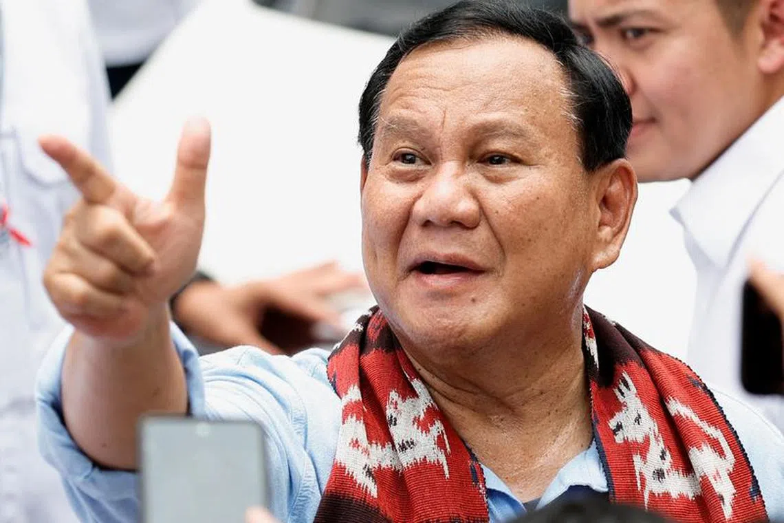 FILE PHOTO: Indonesia's defence minister and presidential candidate, Prabowo Subianto greets the supporters after registering himself for next year's presidential election, at the election commission headquarters in Jakarta, Indonesia, October 25, 2023. REUTERS/Willy Kurniawan/File Photo