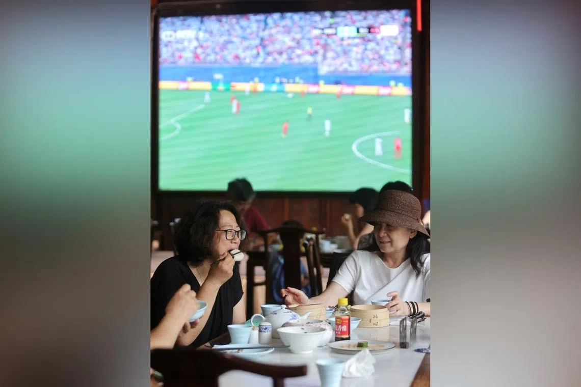 Customers enjoy morning tea in front of a World Cup live stream at a teahouse in Yangzhou, Jiangsu province.