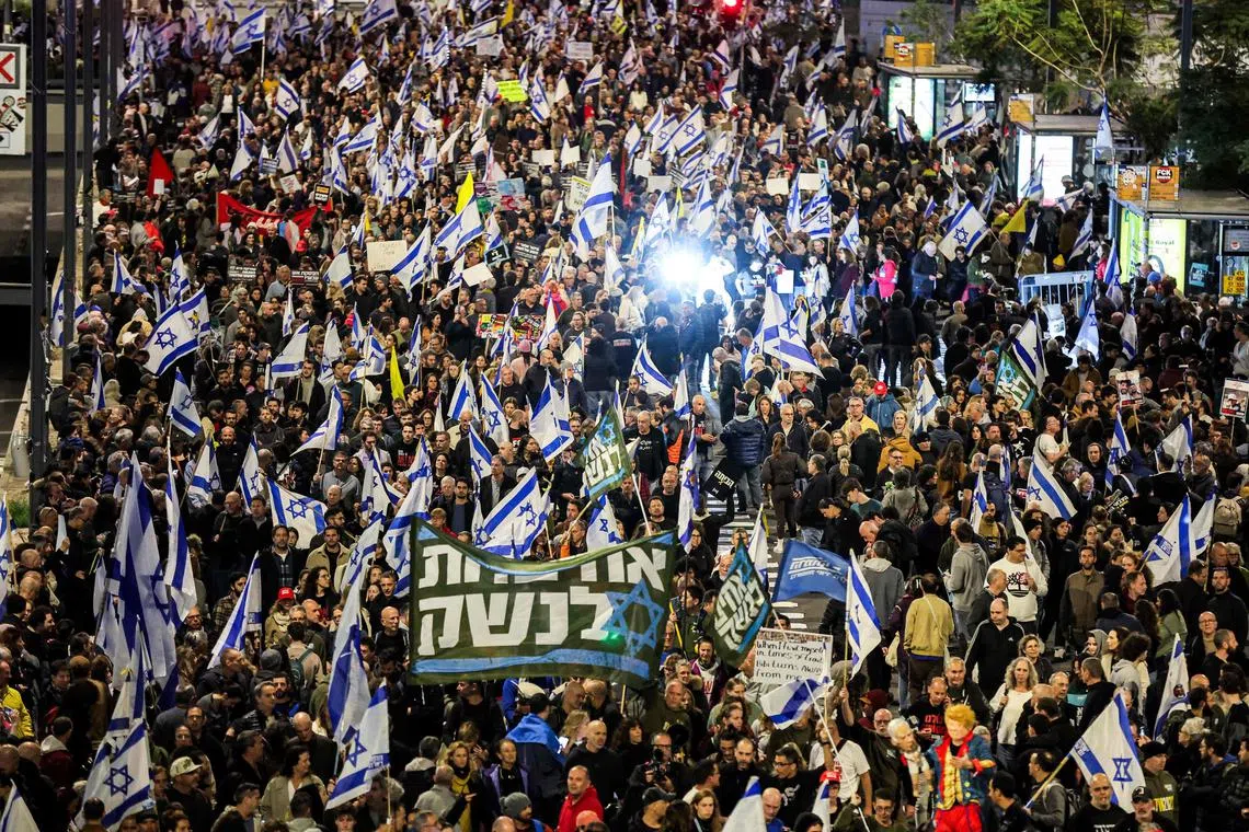 Demonstrators gathering outside the Israeli Defence Ministry headquarters in Tel Aviv on March 22, during an anti-government protest calling for action to secure the release of Israeli hostages held captive in the Gaza Strip since Hamas' Oct 7, 2023, attacks.