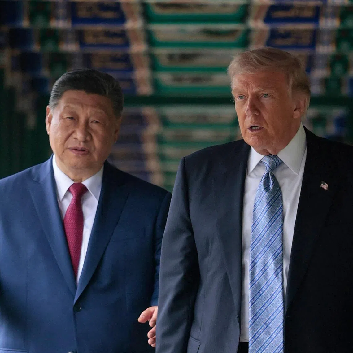 US President Donald Trump (R) walks with China’s President Xi Jinping (L) at Zhongnanhai Garden in Beijing on May 15, 2026. (Photo by Evan Vucci / POOL / AFP)