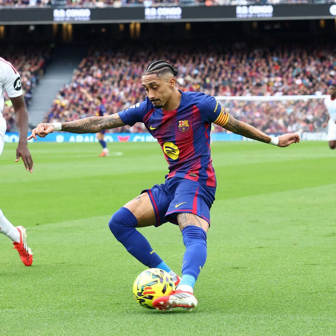 Soccer Football - LaLiga - FC Barcelona v Sevilla - Spotify Camp Nou, Barcelona, Spain - March 15, 2026 FC Barcelona's Raphinha in action with Sevilla's Tanguy Nianzou REUTERS/Albert Gea