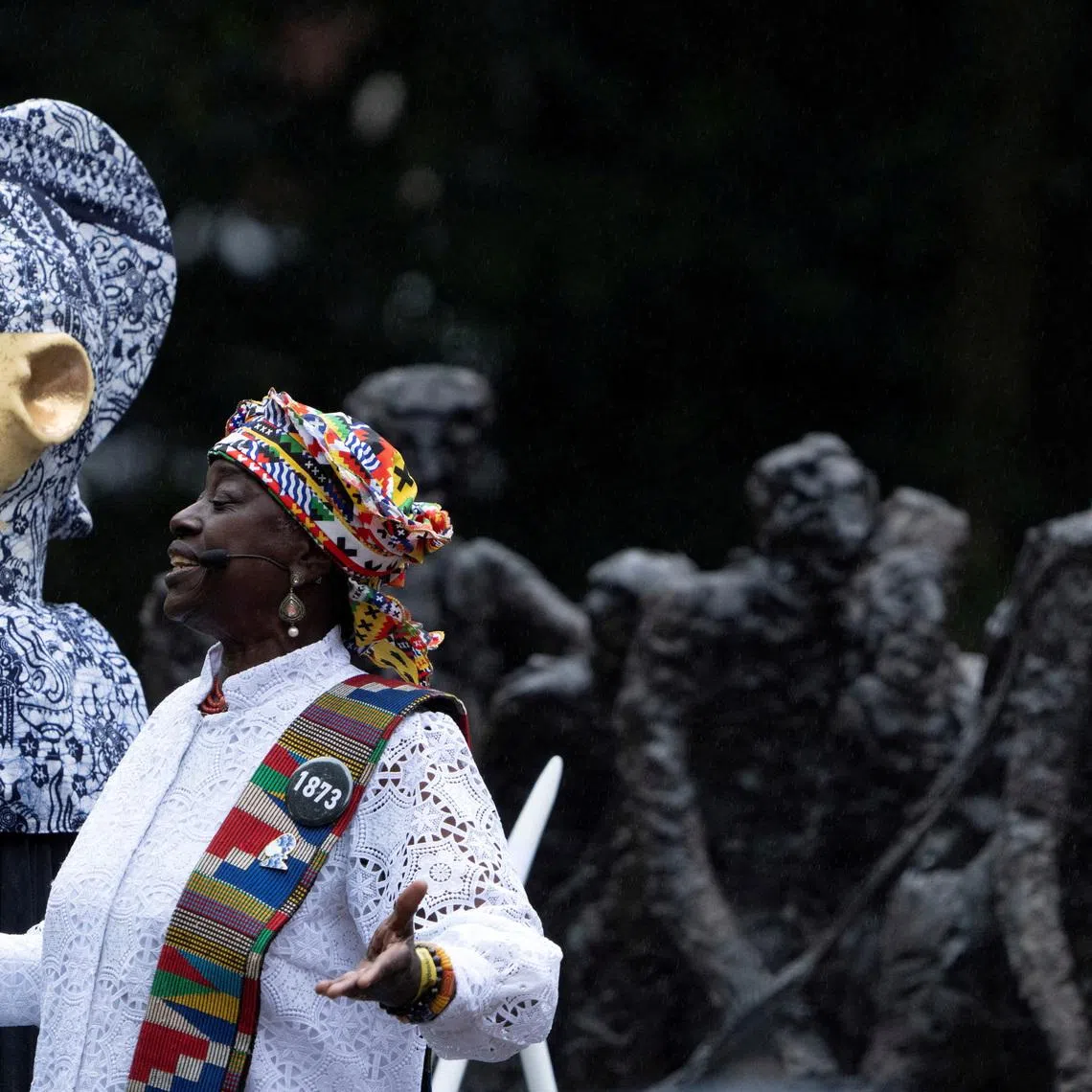 FILE PHOTO: Winti priest Marian Markelo carries out a libation at the slavery monument prior to a speech by Dutch King Willem-Alexander in which apologised for the royal house's role in slavery and asked for forgiveness at an event to commemorate the anniversary of the abolition of slavery by the Netherlands, in Amsterdam, Netherlands, Saturday, July 1, 2023. Peter Dejong/Pool via REUTERS/File Photo