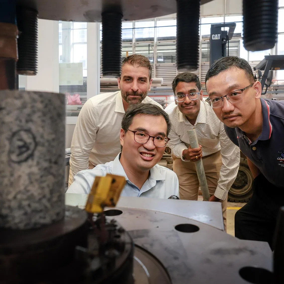 From front, clockwise: 
Dr Jonathan Poh, Research Fellow, Energy Research Institute @ NTU; 

Prof Alessandro Romagnoli, Cluster Director, Multi-Energy Systems & Grids; 

Anurag Chidire, Research Associate, TUMCREATE; 

and Assoc Prof Wu Wei, Associate Chair (Research), School of Civil and Environment Engineering; 

with a core sample in a hydraulic press at a laboratory in NTU on July 3, 2025.