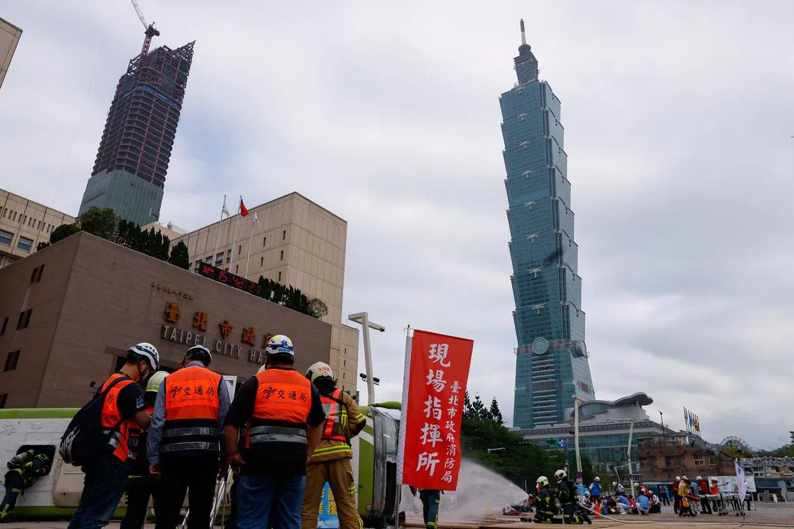 People take part in the annual Minan civilian defense drill, which this year focuses on the response from various agencies and volunteer groups if under attack by China in front of Taipei City hall in Taipei, Taiwan May 4, 2023. REUTERS/Ann Wang