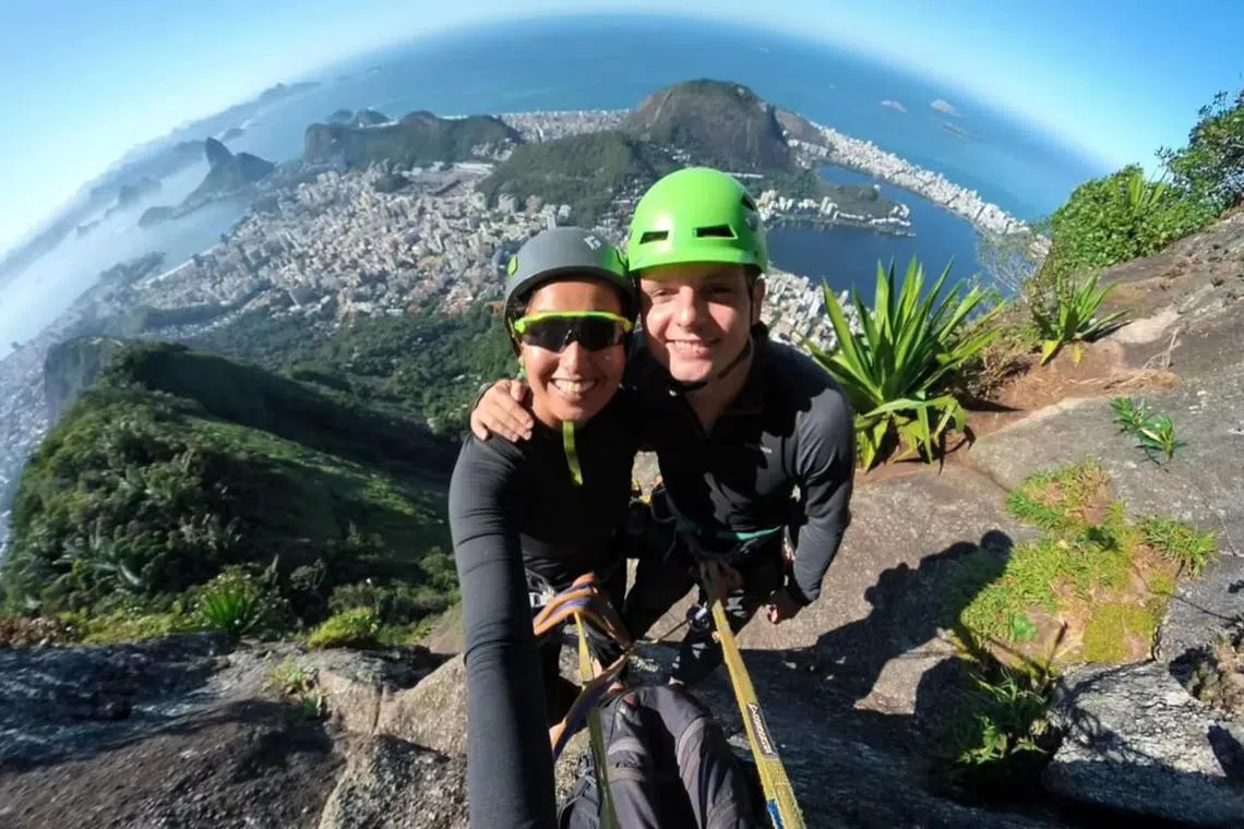 vltravel - Sunlife feature on travelling with a purpose: Ms Michelle Verma, 39, and her husband Mariusz Kozlowski, 35, combine sight-seeing with rock-climbing. Climbing together strengthens their bond and helps them connect with local guides. They are pictured here in August 2024, dangling 710m above ground, climbing to the summit at Mount Corcovado, Rio de Janeiro, Brazil, where the famous colossal Christ the Redeemer statue is located.

PHOTO COURTESY OF: Michelle Verma
(One time use)