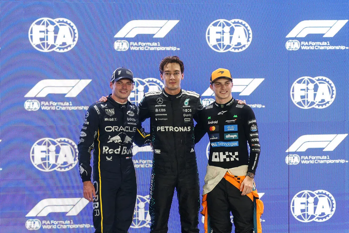(From left) Red Bull's Max Verstappen, Mercedes' George Russell and McLaren's Oscar Piastri posing for a photo after the qualifying session of the 2025 Formula One Singapore Airlines Singapore Grand Prix at the Marina Bay Street Circuit on Oct 4, 2025.  