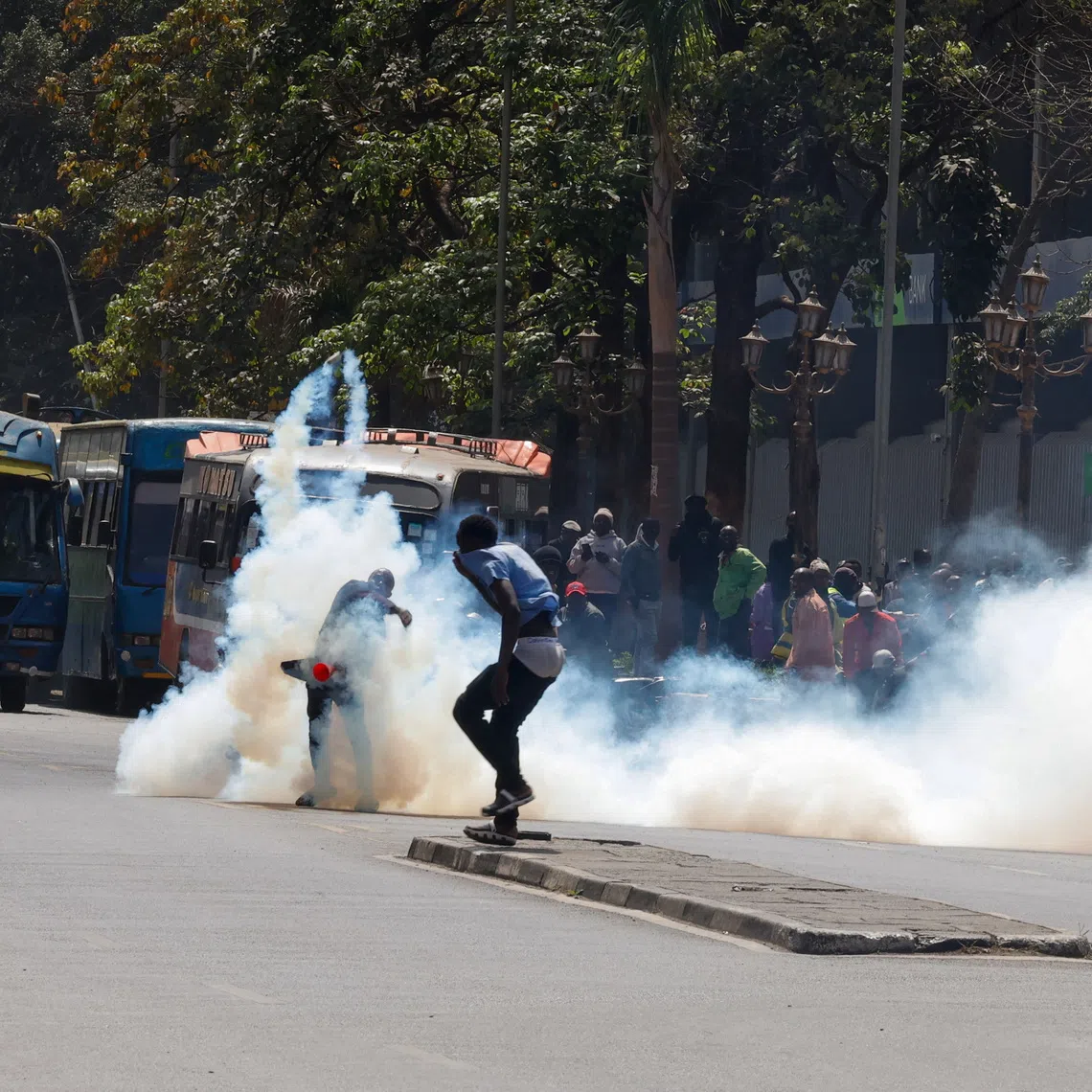 A demonstrator throws away a tear gas canister as traders hold a protest over a new Kenya Revenue Authority (KRA) customs valuation benchmark in downtown Nairobi, Kenya, August 28, 2026. REUTERS/Monicah Mwangi
