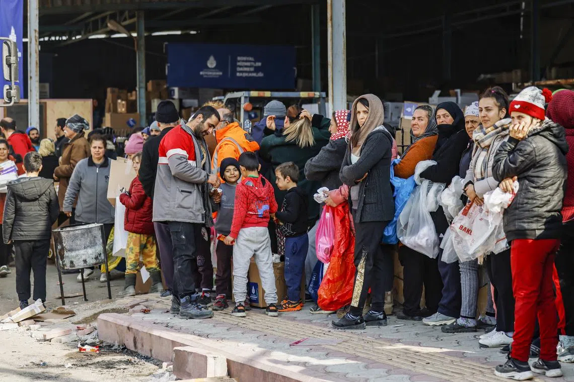 Residents queueing for humanitarian aid in Samandag, Turkey, on Sunday.
