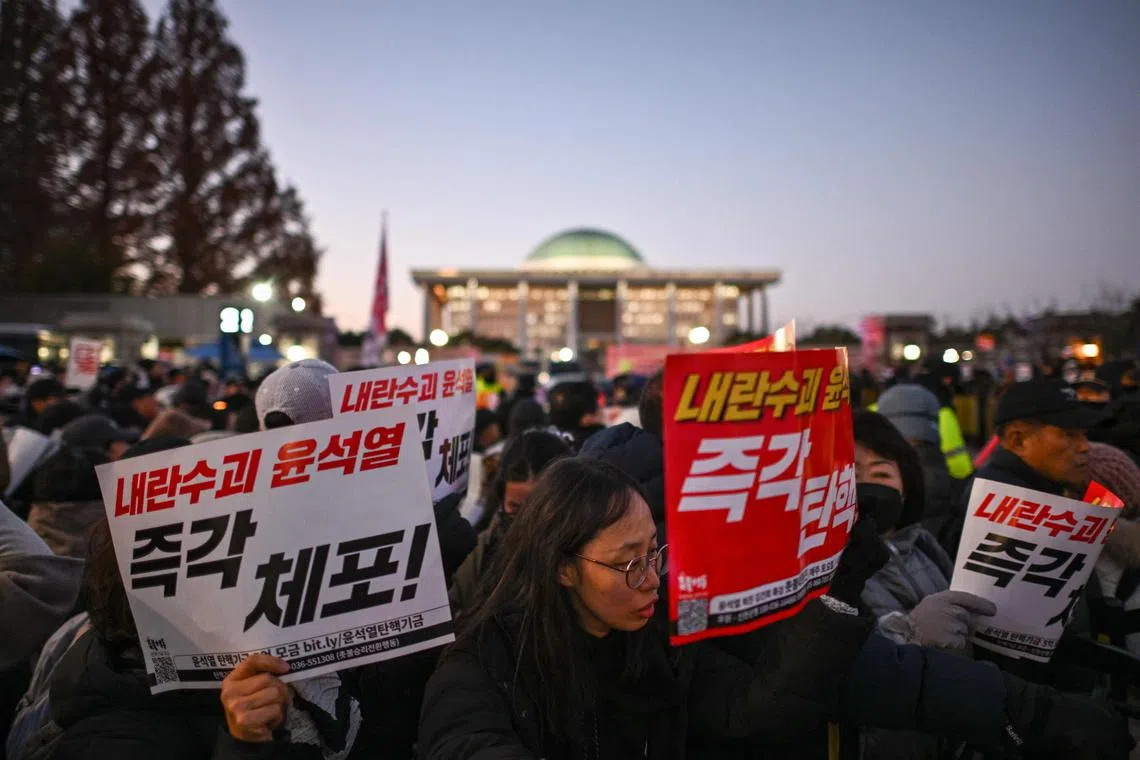 Protestors calling for the ouster of South Korea President Yoon Suk Yeol outside the National Assembly in Seoul on Dec 6, 2024.