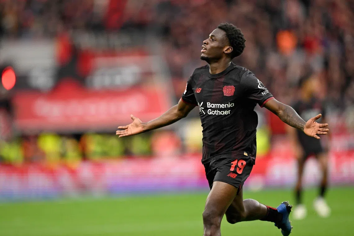 Bayer Leverkusen's Dutch forward Ernest Poku celebrates scoring the opening goal.