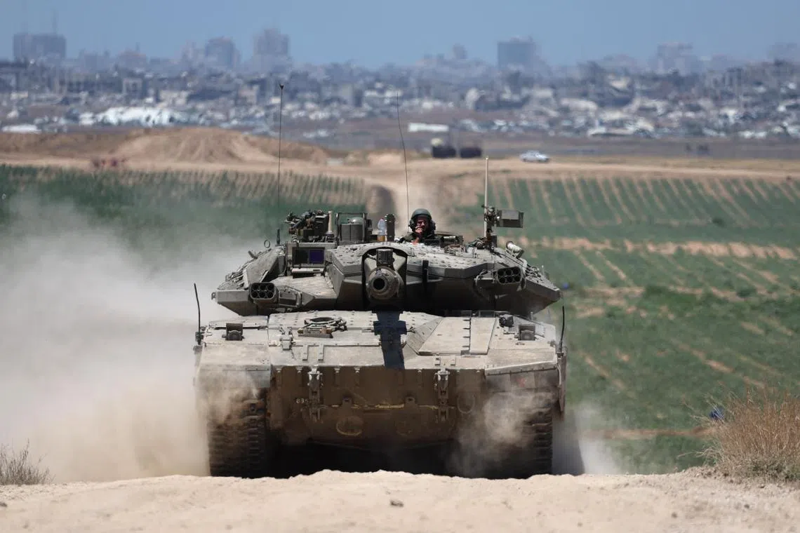 Israeli tanks patrol near the security fence with Jabalia, in the northern part of the Gaza Strip.
