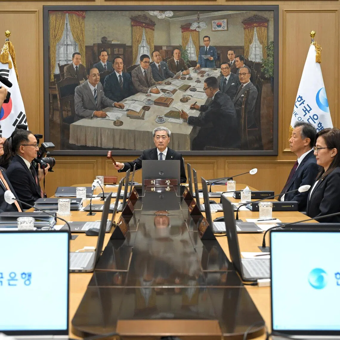 Bank of Korea Governor Shin Hyun-song bangs the gavel to open a Monetary Policy Committee meeting at the central bank in Seoul on Aug 27.