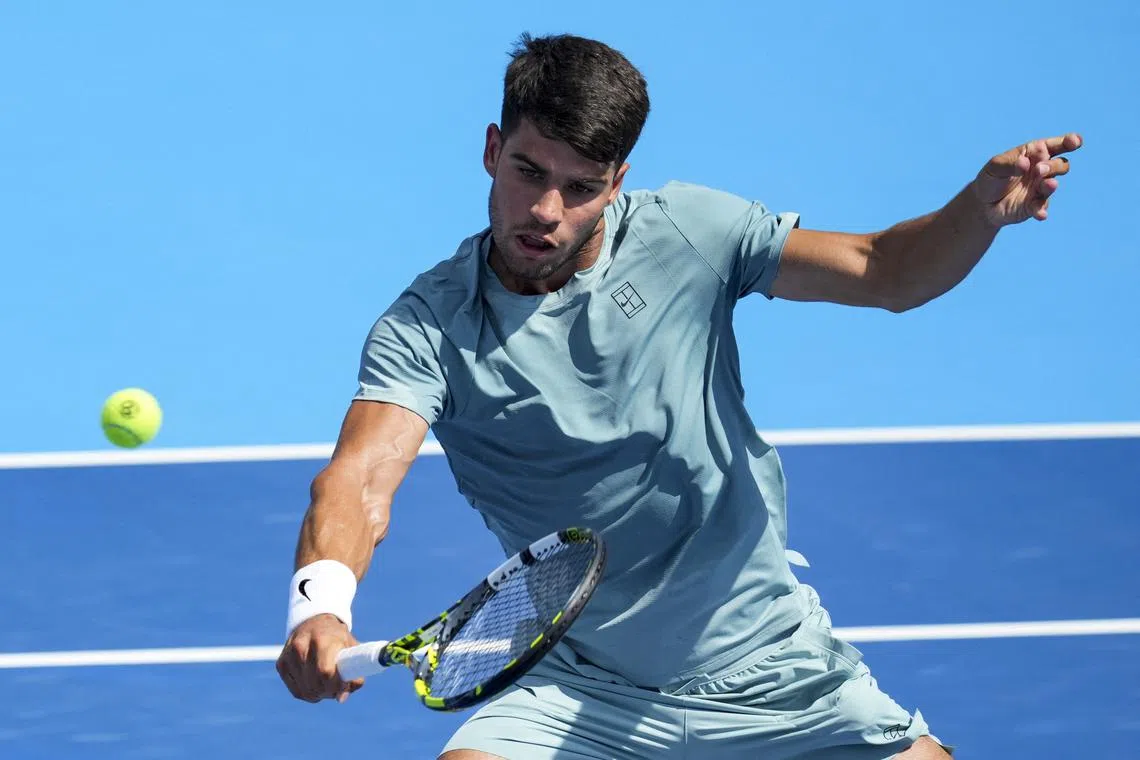 Aug 10, 2025; Cincinnati, OH, USA;  Carlos Alcaraz (ESP) returns a shot against Damir Dzumhur (BIH) during the Cincinnati Open at the Lindner Family Tennis Center. Mandatory Credit: Aaron Doster-Imagn Images