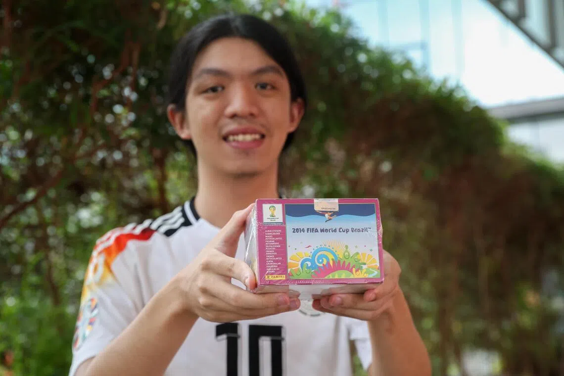 Lucas Leo first began collecting Panini stickers in 2014. Here, he is holding a sealed box of Panini stickers from the 2014 FIFA World Cup Brazil.