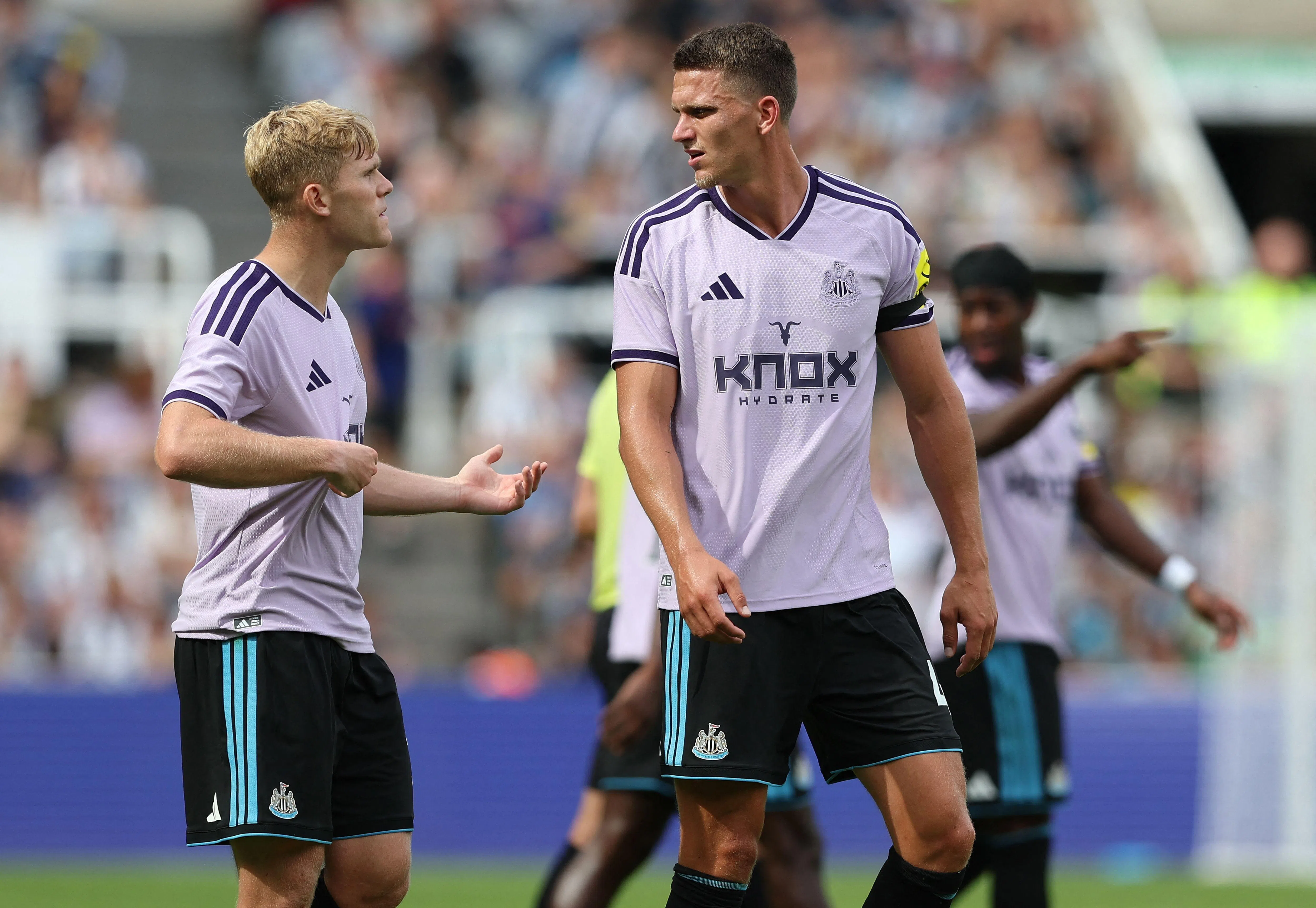 Newcastle United midfielder Lewis Hall (left) and defender Sven Botman talking after a complete team kit-change during a hydration break in their pre-season friendly football match against Bayer Leverkusen at St James’ Park on Aug 15.