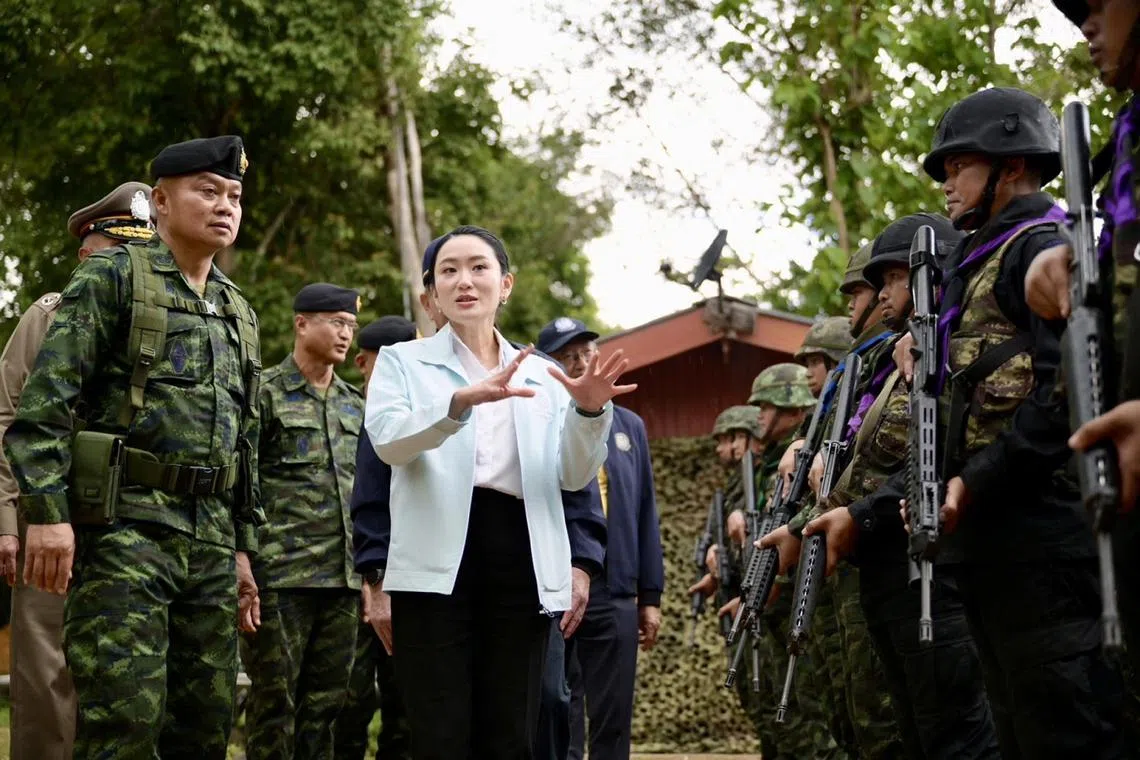 Thai PM Paetongtarn Shinawatra, accompanied by Lieutenant-General Boonsin Padklang, whom she had disparaged in the leaked phone call, visiting an army base near the Cambodian border on June 20.