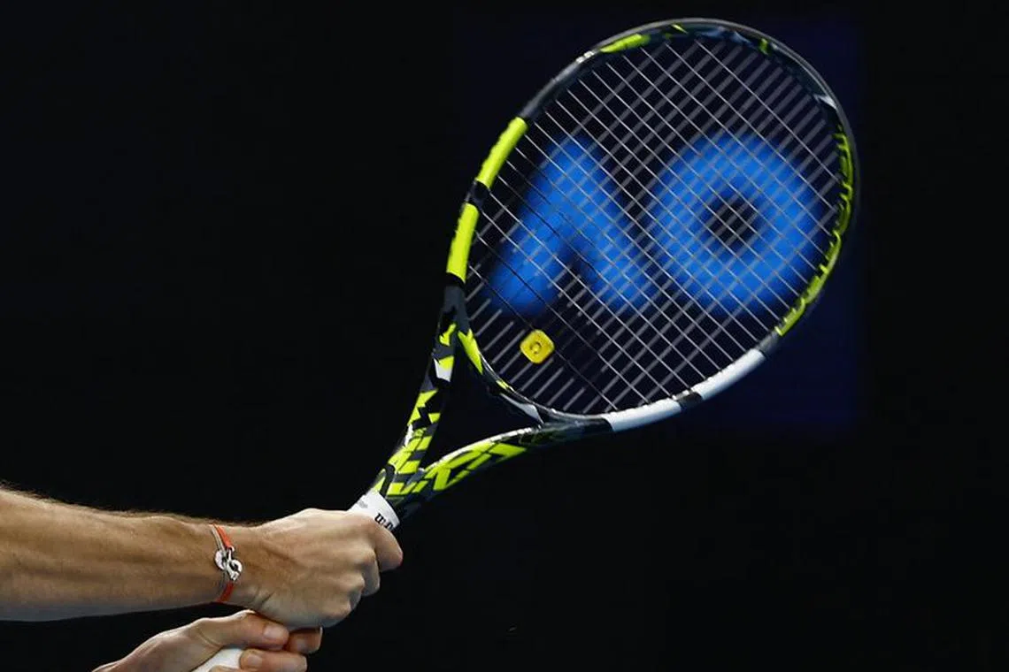 Tennis - Australian Open - Melbourne Park, Melbourne, Australia - January 19, 2024 General view as the Australian Open logo is seen through the racket of France's Adrian Mannarino during his third round match against Ben Shelton of the U.S. REUTERS/Issei Kato/File Photo
