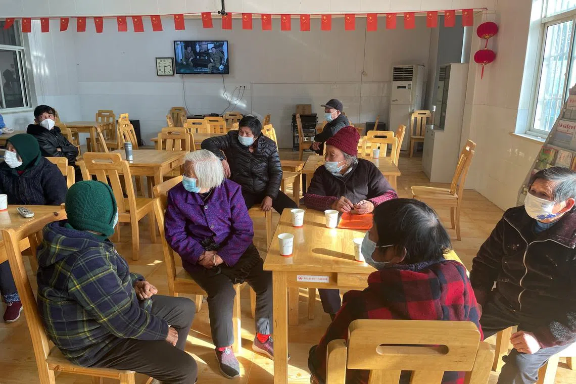 Elderly residents waiting at a Covid-19 vaccination centre on the outskirts of Shanghai during a government-organised visit on Dec 21.