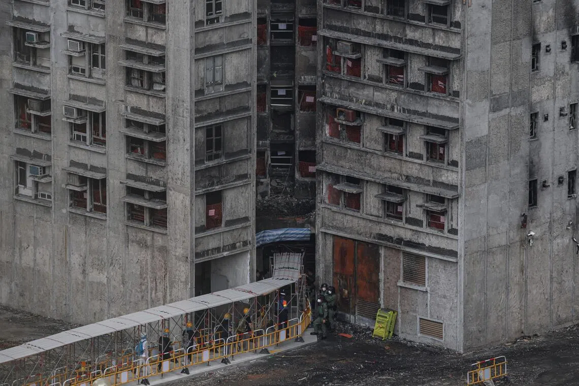 Residents walk towards a building at Wang Fuk Court to retrieve personal belongings, in Hong Kong, China, on April 21.