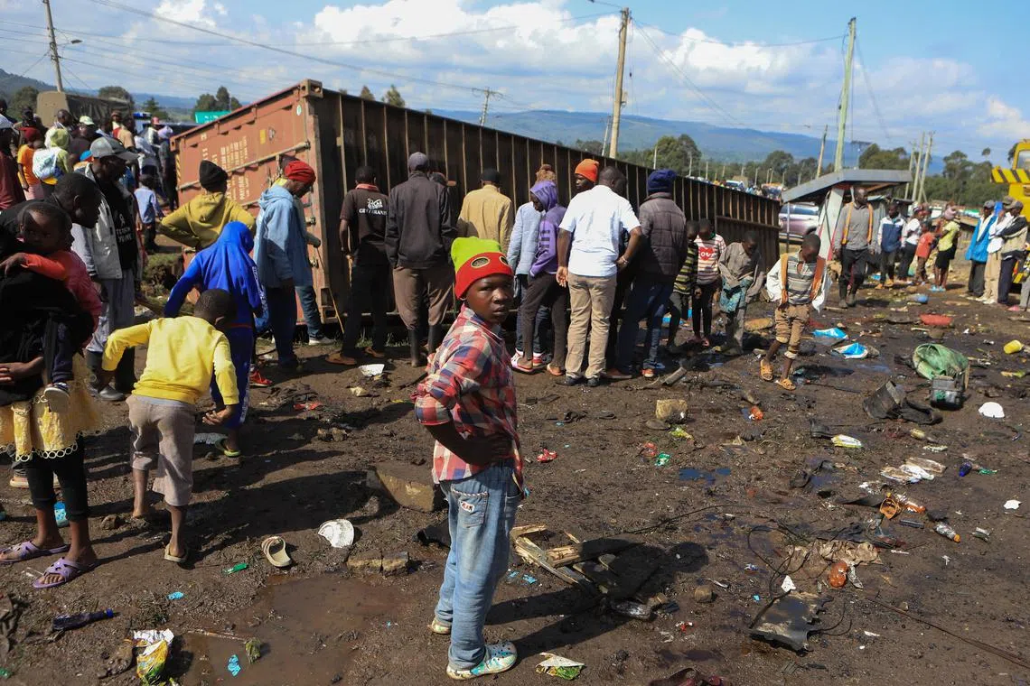 An out-of-control truck carrying a shipping container ploughed into multiple other vehicles and people thronging a busy roadside junction.