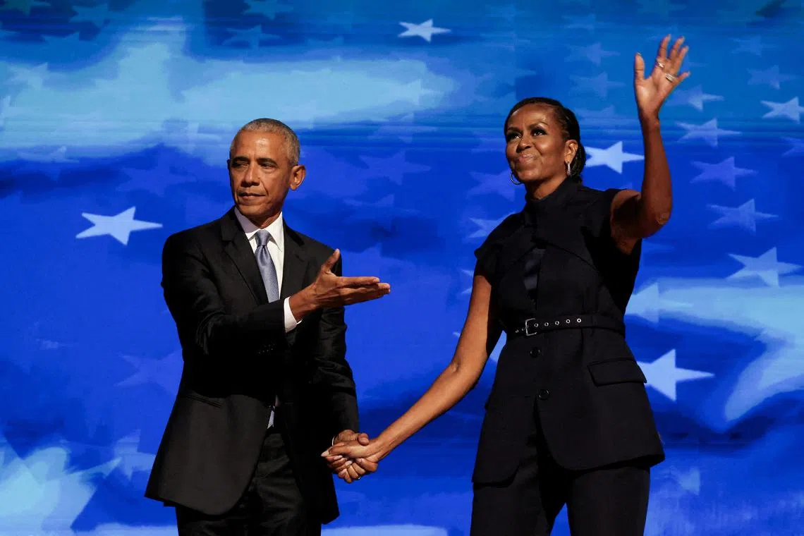 FILE PHOTO: Former U.S. first lady Michelle Obama greets her husband, former U.S. President Barack Obama, on stage during Day 2 of the Democratic National Convention (DNC) in Chicago, Illinois, U.S., August 20, 2024. REUTERS/Alyssa Pointer/File Photo