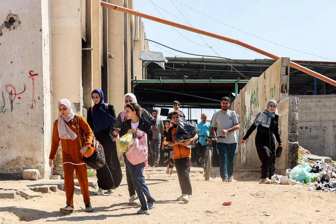 People evacuate from a displacement shelter in the Jabalia camp for Palestinian refugees in the northern Gaza Strip on Oct 9. 