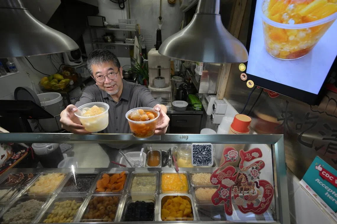 hkpatrick15/ST20260716_202665400935/Ng Sor Luan/Singaporean Patrick Tay, 61, is an interior designer turned hawker. After spending years abroad in Beijing, he now runs hawker stall Tuan Tuan Yuan Yuan in Chinatown Complex selling desserts like Cheng Tng, Yuzu Ice and Mango Sago.  His daughter, Nichole Tay, 28, founder of storytelling social app Phases currently helps out at the stall.