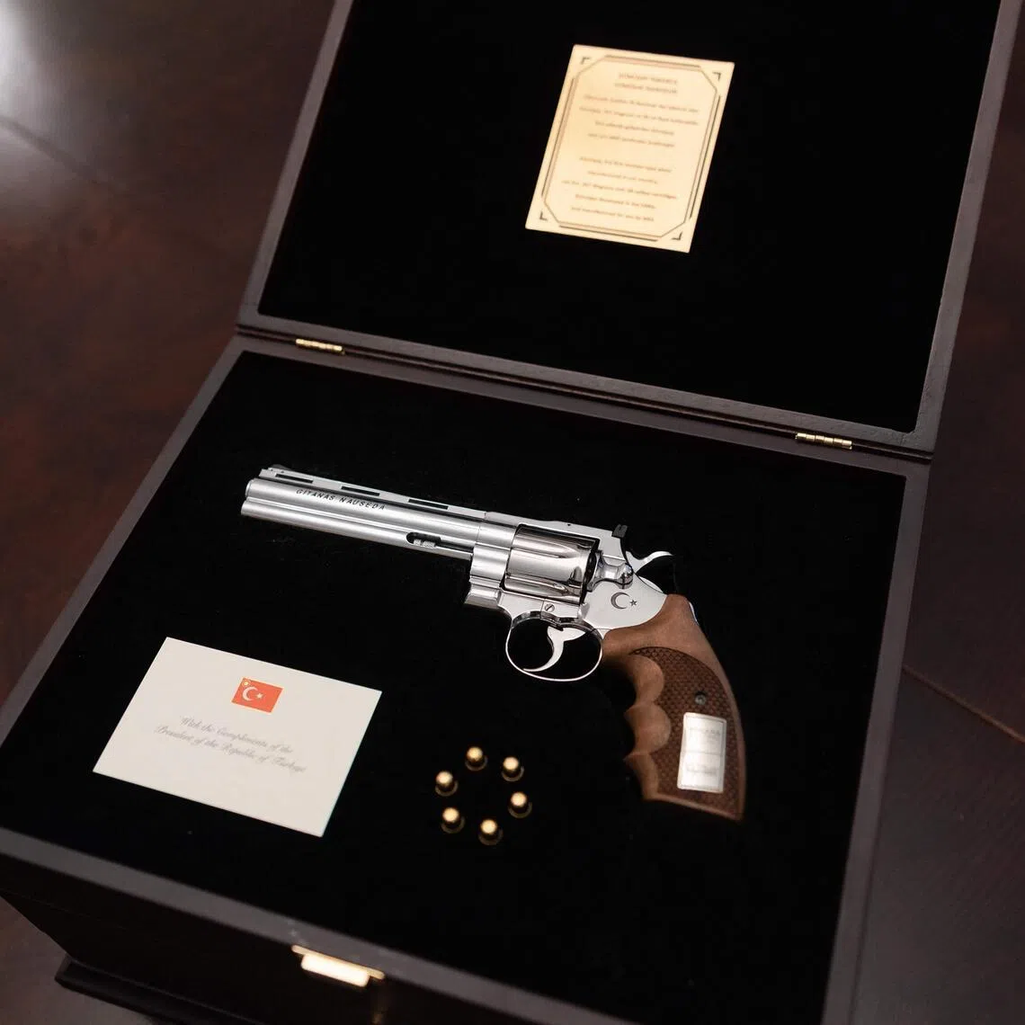 A photo from the office of the Lithuanian president showing the revolver offered by Turkish President Recep Tayyip Erdogan to Lithuanian President Gitanas Nauseda with the president’s name engraved on it, and live rounds. The weapon was displayed during a press presentation in Vilnius, Lithuania.