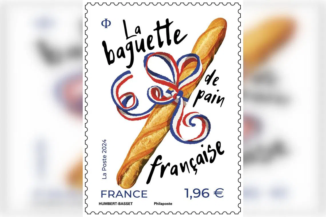 The stamp depicts a baguette decorated with a blue-white-red ribbon.