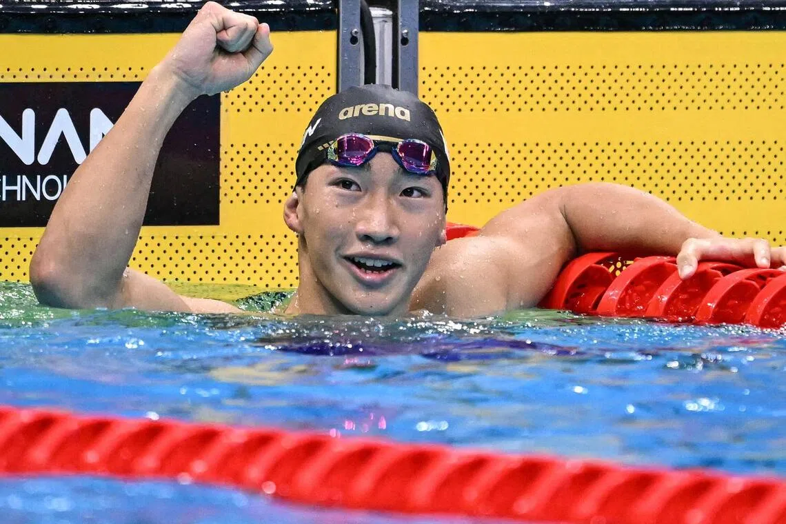 Japan’s Shin Ohashi celebrates after breaking men’s 200m breaststroke world record at the Asian Games.
