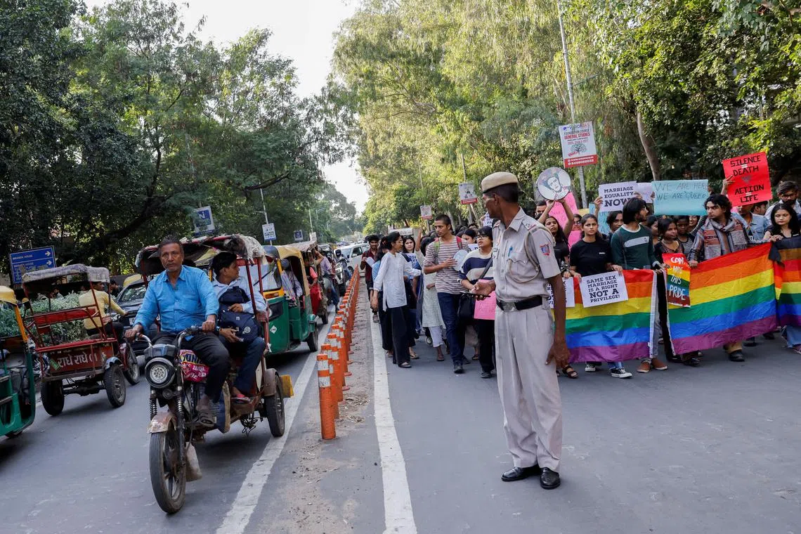 FILE PHOTO: Students and supporters of the Students' Federation of India (SFI) shout slogans, hold placards and pride flags as they take part in an LGBT+ Pride vigil organised after India's top court on Tuesday declined to legalise same-sex marriage and left it to parliament to decide, at North Campus in New Delhi, India, October 18, 2023. REUTERS/Anushree Fadnavis/File Photo