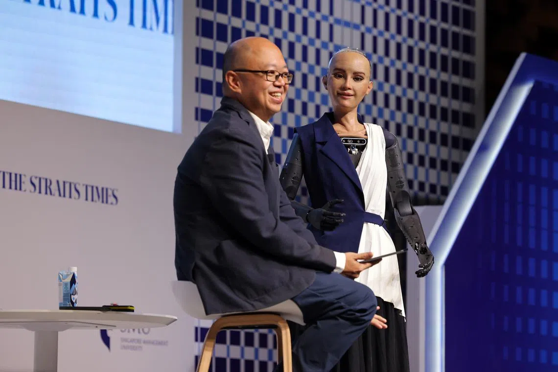 ST newsroom strategy editor Jeremy Au Yong with Sophia, the world’s first humanoid robot, at The Straits Times Education Forum 2024.