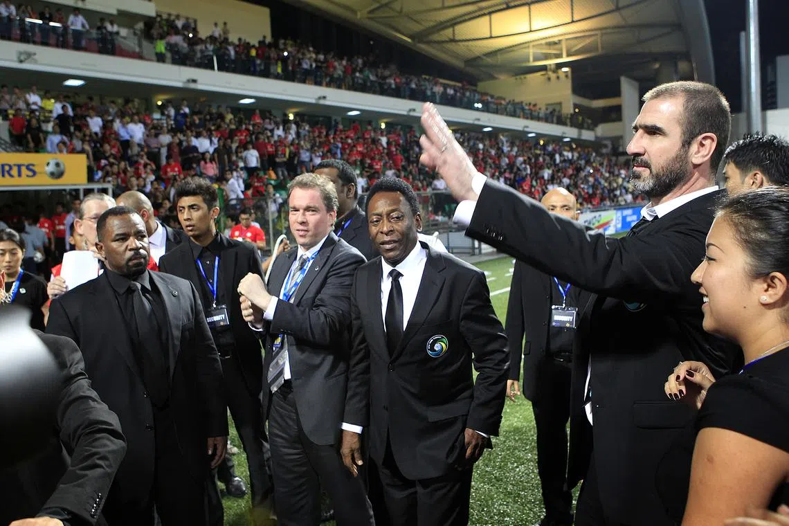 Football legends Eric Cantona and Pele greeting fans during half-time of the S-League match between Courts Young Lions and Geylang United held at the Jalan Besar Stadium on 3 March 2011. They were in Singapore as part of a tie-up between New York Cosmos and Courts. Pele, 71, is the President of the American club while Cantona, 44, is the club's director of football. 3,000 fans turned up at the stadium to catch the football legends's first public appearance in Singapore.