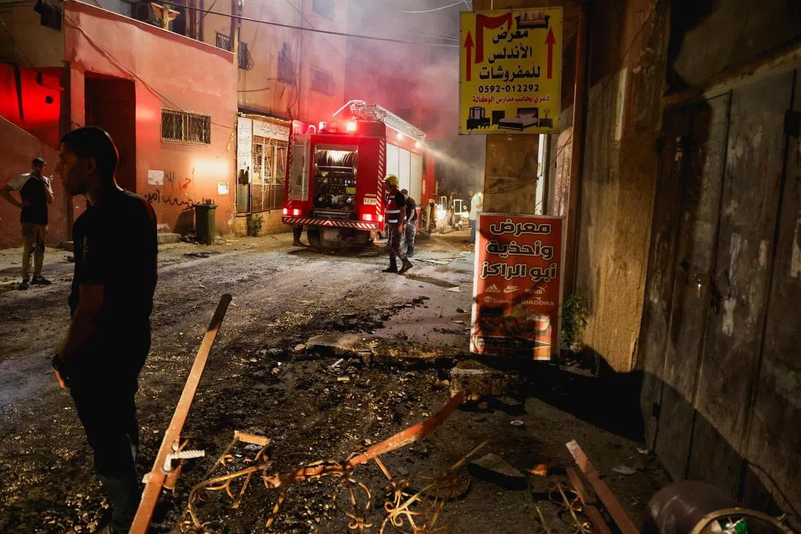 Emergency services work as Israeli troops start withdrawing from Jenin, in the Israeli-occupied West Bank.