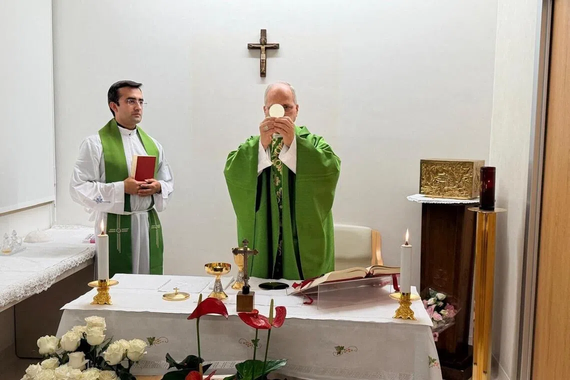 Pope Leo celebrating mass in a room in Rome’s Gemelli Hospital, attended by off-duty medical staff and members of the Vatican Gendarmerie, on Oct 16.