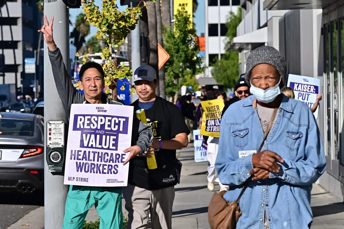 Kaiser Permanente employees are joined by Union members representing the workers on the first day of a 3-day strike in Los Angeles, California on October 4, 2023. More than 75,000 employees at Kaiser Permanente began one of the largest healthcare worker strikes in recent US history on Wednesday after failing to resolve a dispute over staffing levels. (Photo by Frederic J. BROWN / AFP)
