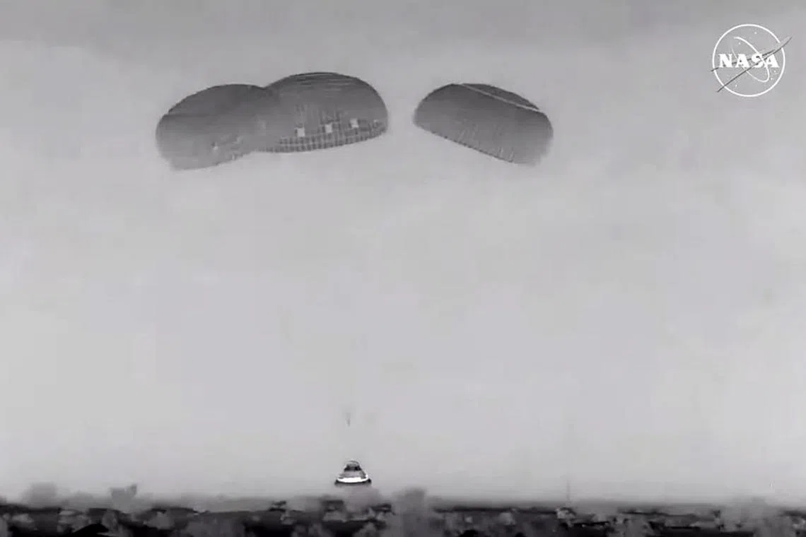 Boeing’s Starliner deployed parachutes before touching down in a New Mexico desert in the US, seen here in a video still taken on Sept 6.