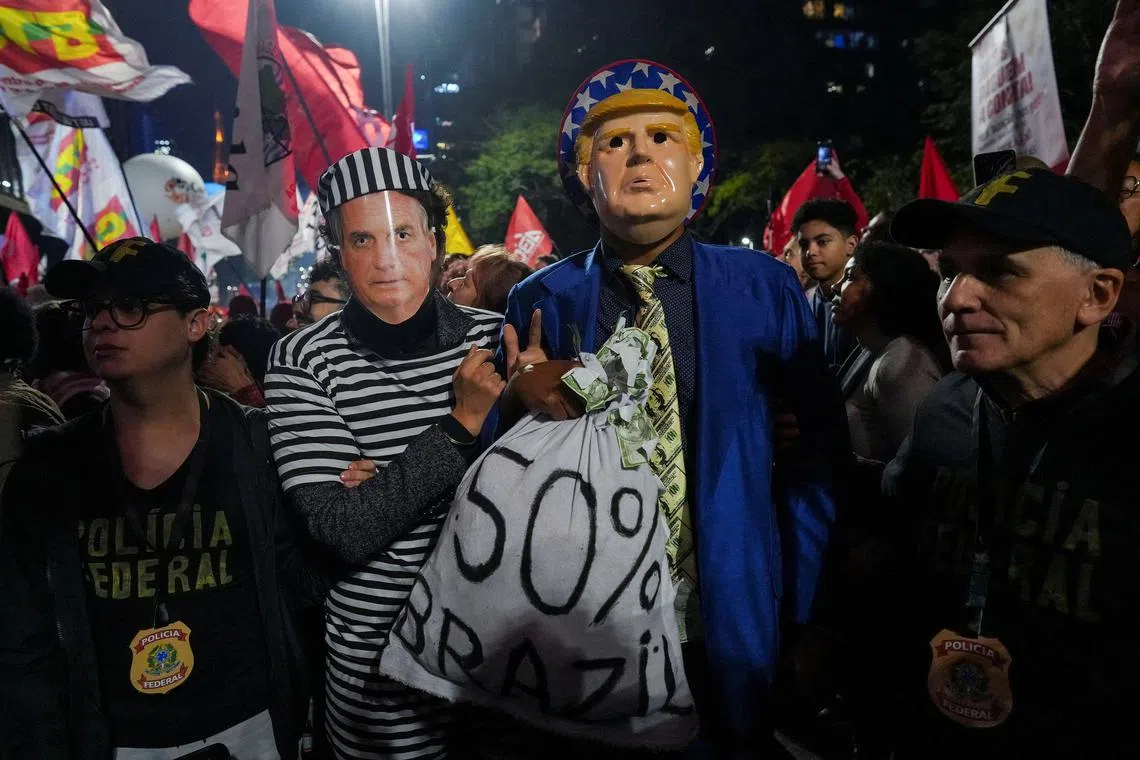 FILE PHOTO: Demonstrators wearing costumes and masks depicting former Brazilian President Jair Bolsonaro and U.S. President Donald Trump take part in a protest against U.S. President Donald Trump's announcement of 50% tariffs on Brazilian products, in Sao Paulo, Brazil July 10, 2025. REUTERS/Alexandre Meneghini/File Photo