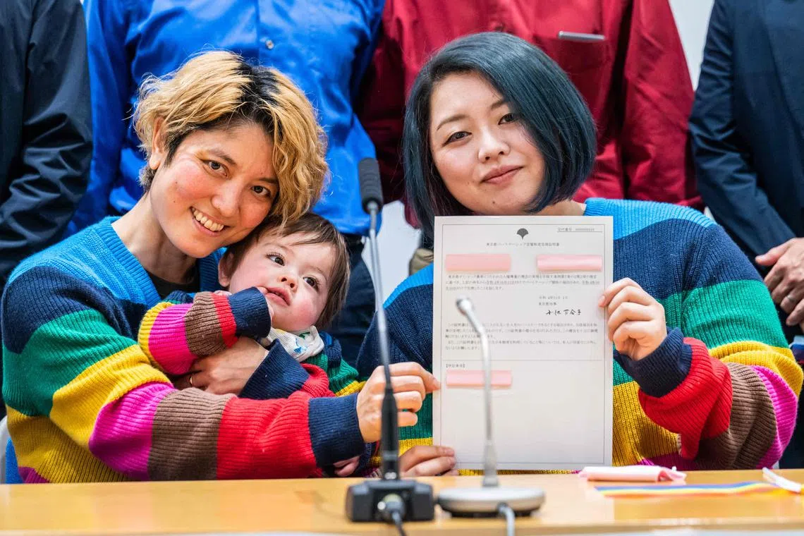 Mamiko Moda (left), her partner Satoko Nagamura and their son with a same-sex partnership certificate in Tokyo.